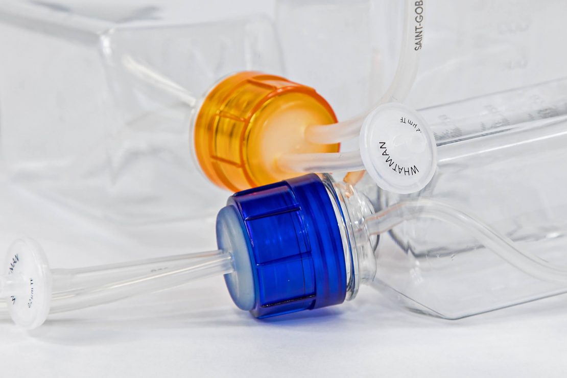 MXC³ color caps in front of bottle